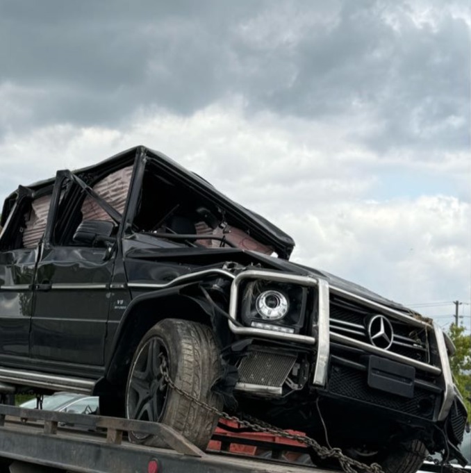 Damaged black Mercedes-Benz G-Class on a recovery truck
