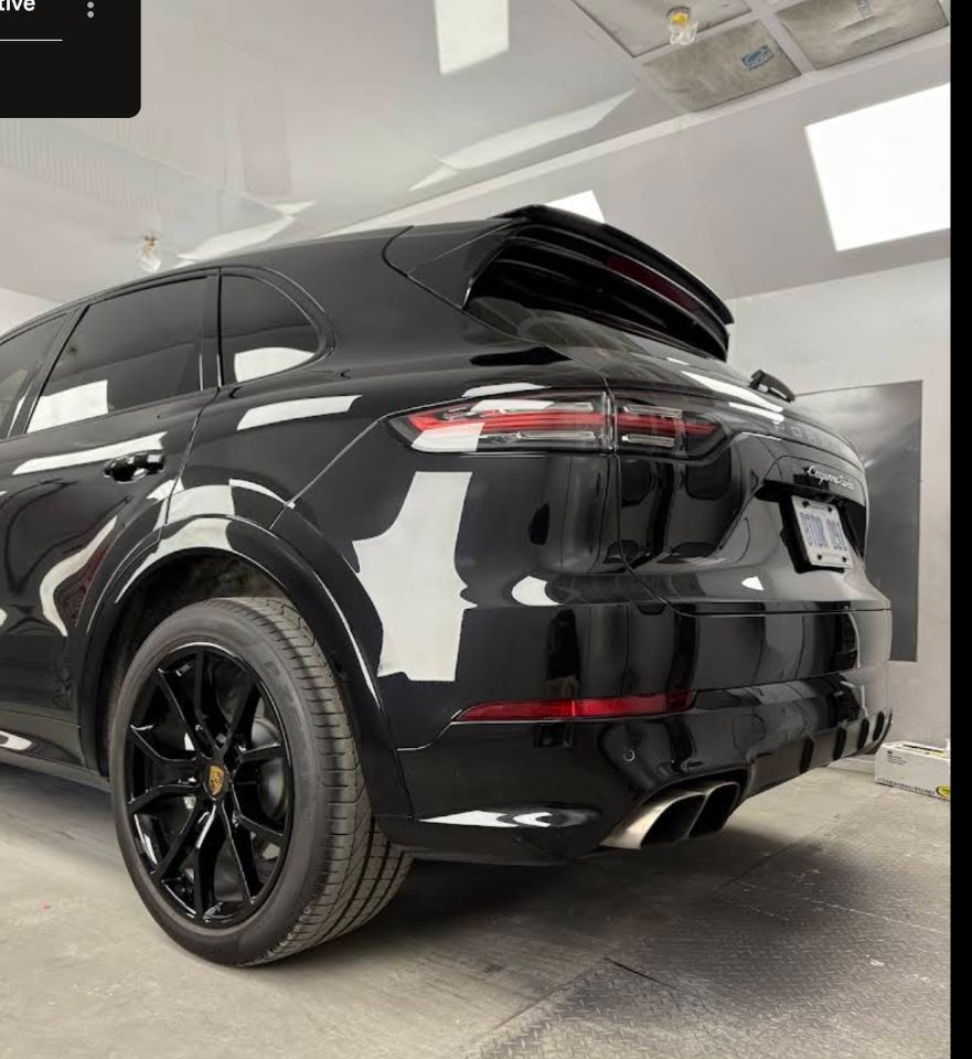 Black Porsche in the paint booth